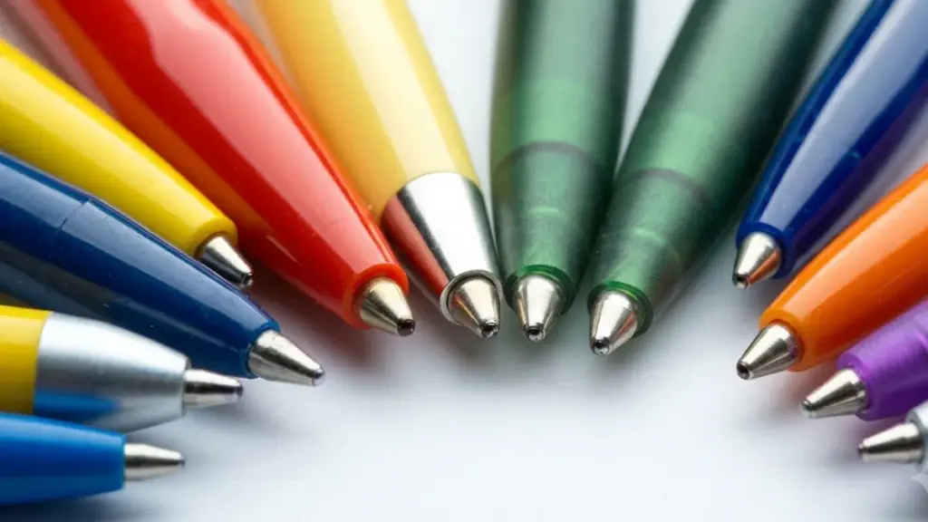 Close-up of colorful ballpoint pens arranged in a semi-circle