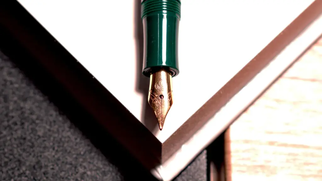 Extreme close-up of a green fountain pen gold nib