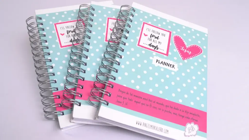 Three light blue polka dot spiral planners on white background