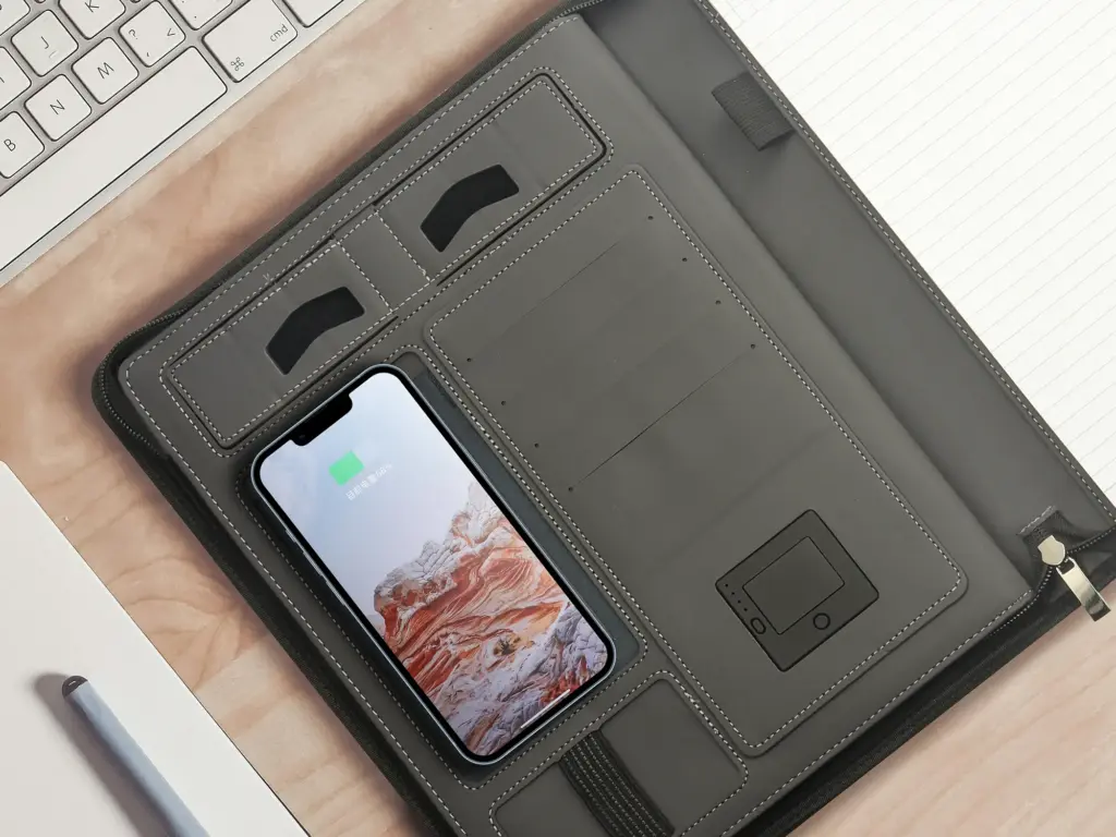 Gray power bank notebook with phone pocket and card slots on the cover