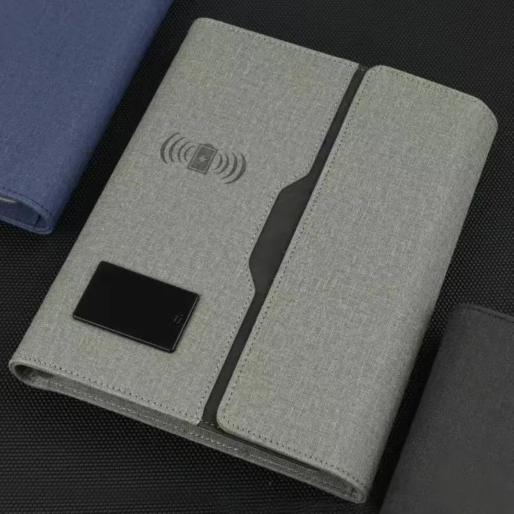 Gray fabric RFID blocking wallet with NFC symbol printed on front, displayed on dark textured surface alongside blue and black variants